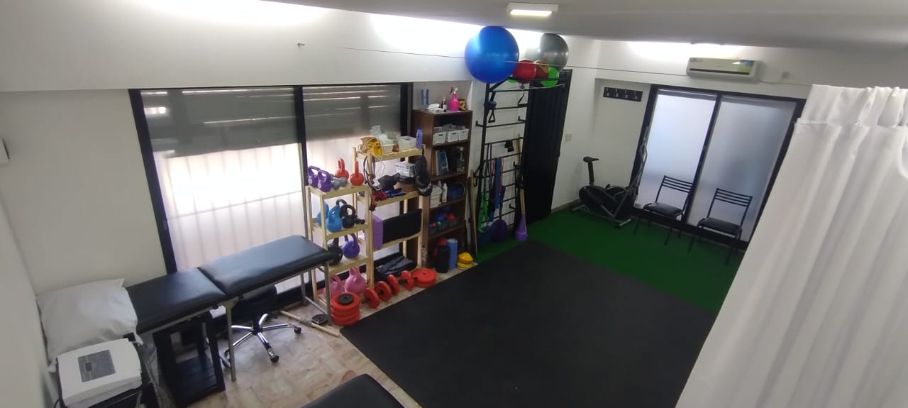 Consultorio de kinesiología con equipamiento de rehabilitación